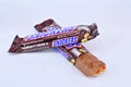 Chocolate bar snickers on a white background Royalty Free Stock Photo