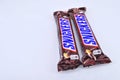 Chocolate bar snickers on a white background Royalty Free Stock Photo