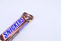 Chocolate bar snickers on a white background Royalty Free Stock Photo