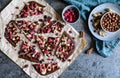 Chocolate bark with hazelnuts, peanuts, cranberries and freeze dried raspberries Royalty Free Stock Photo