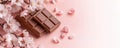 Chocolate bars with cherry blossoms and petals on soft pink background Royalty Free Stock Photo
