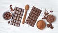 Chocolate bars with cocoa beans and bowl of chocolate chips and cacao powder for confectionery Royalty Free Stock Photo