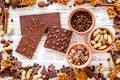 Chocolate bars of different varietes on grey wooden background top view