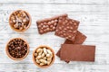 Chocolate bars of different varietes on grey wooden background top view