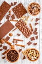 Chocolate bars of different varietes on grey wooden background top view