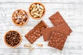 Chocolate bars of different varietes on grey wooden background top view