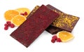 Chocolate bars with freeze dried fruits, raspberries and orange slices on white background Royalty Free Stock Photo