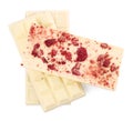 Chocolate bars with freeze dried raspberries on white background, top view Royalty Free Stock Photo