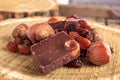 Chocolate bars with nuts and raisins on wooden stump Royalty Free Stock Photo