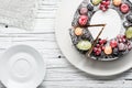 Chocolate berry cake on plate over white wooden background Royalty Free Stock Photo