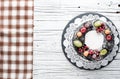 Chocolate berry cake on plate over white wooden background Royalty Free Stock Photo