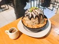 Chocolate bingsu with topping such as Coaco sauce, Sweetened condensed milk, Peppermint and corn flake. Chocolate sauce in small