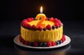 chocolate birthday cake with berries and lighted candle in shape of number two on black backdrop Royalty Free Stock Photo