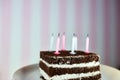 Chocolate birthday cake with candles. Birthday cake with burning candles on color pink background. Royalty Free Stock Photo