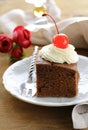 Chocolate birthday cake with cherries and cream