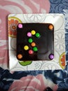 Chocolate birthday cake with different colors gems candy