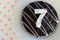 Chocolate birthday cake for a seventh birthday or anniversary ce Royalty Free Stock Photo