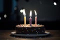 chocolate birthday cake with three candles and colorful sprinkles Royalty Free Stock Photo