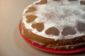 Chocolate Biscuit Cake with Cocoa Cream with Small Hearts from Powdered Sugar. Dessert. Valentine`s Day Concept.