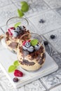 Chocolate dessert in glasses with raspberries and blueberries