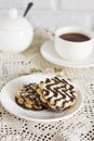 Chocolate biscuits on white plate and Cup of tea on table Royalty Free Stock Photo