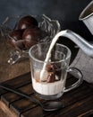 Chocolate bonbon with hazelnut cream filling in a clear glass cup, .