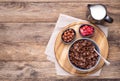 Chocolate breakfast cereal in a bowl on rustic wooden table, top view with copy space