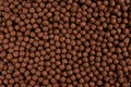 Chocolate breakfast cereal texture. Cereal balls as background. Top view Royalty Free Stock Photo