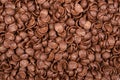 Chocolate breakfast cereals closeup, food background, top view