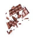 Chocolate broken into many pieces in the air on a white background