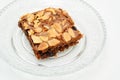 Chocolate brownie with almond topping on glass plated Royalty Free Stock Photo