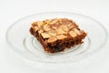 Chocolate brownie with almond topping on glass plated Royalty Free Stock Photo