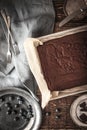 Chocolate brownie on the baking tray with blueberry and dinnerware