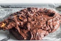 Chocolate brownie batter mix being filled in baking pan with wooden spoon Royalty Free Stock Photo