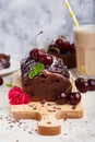 Chocolate brownie cake with cherries and sugar powder