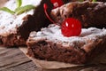 Chocolate brownie cake with cherry closeup on paper. Horizontal Royalty Free Stock Photo