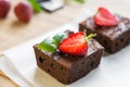 Chocolate brownie cake decorated with strawberries. Selective focus