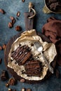 Chocolate brownie cake, dessert with nuts on dark background, directly above