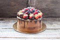 Chocolate brownie cake with fresh summer berries. Decorated with strawberries dipped into melted chocolate. Royalty Free Stock Photo