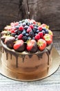 Chocolate brownie cake with fresh summer berries. Decorated with strawberries dipped into melted chocolate. Royalty Free Stock Photo