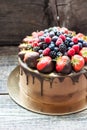 Chocolate brownie cake with fresh summer berries. Decorated with strawberries dipped into melted chocolate. Royalty Free Stock Photo