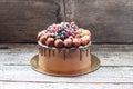 Chocolate brownie cake with fresh summer berries. Decorated with strawberries dipped into melted chocolate. Royalty Free Stock Photo
