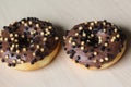 chocolate brownie donuts on table. The donuts is brown glazed with brownie parts