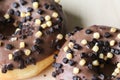 chocolate brownie donuts on table. The donuts is brown glazed with brownie parts