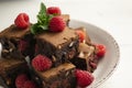 Chocolate brownie with raspberries and cashews. Royalty Free Stock Photo