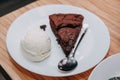 Chocolate brownie with a scoop of ice cream on a white plate. Close up Royalty Free Stock Photo