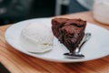 Chocolate brownie with a scoop of ice cream on a white plate. Close up Royalty Free Stock Photo