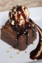 Chocolate brownie with vanilla ice cream ball above Royalty Free Stock Photo