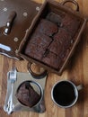 Chocolate brownies in a ceramic form. Piece of cake and coffee in a metal cup and saucer Royalty Free Stock Photo