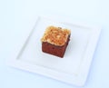 Chocolate brownies on white square plate, Brownie cake topped with nuts